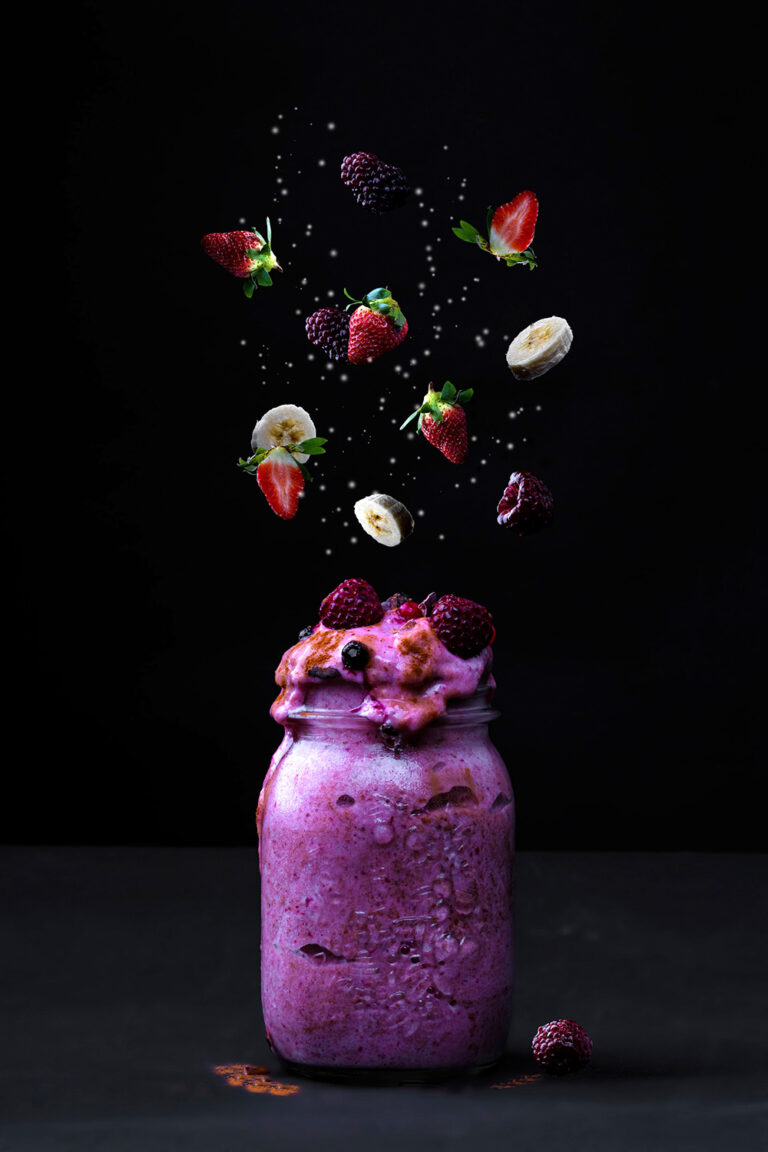 A Clear Glass Jar Bursting with Red and Green Fruits